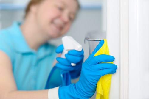 Staff member using protective gloves and safe cleaning products